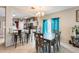 Dining area with a kitchen island and teal curtains at 14206 W Mandalay Ln, Surprise, AZ 85379