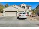 Two-story house with a three-car garage and desert landscaping at 14206 W Mandalay Ln, Surprise, AZ 85379