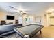 Spacious game room with pool table and access to other rooms at 14206 W Mandalay Ln, Surprise, AZ 85379