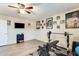 Home gym with weight bench, weights, and TV at 14206 W Mandalay Ln, Surprise, AZ 85379