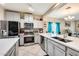 Eat-in kitchen featuring stainless steel appliances and double sink at 14206 W Mandalay Ln, Surprise, AZ 85379