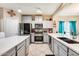 Modern kitchen with stainless steel appliances and an island at 14206 W Mandalay Ln, Surprise, AZ 85379