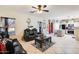 Open living room and kitchen layout with black leather seating at 14206 W Mandalay Ln, Surprise, AZ 85379