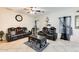 Living room with black leather reclining sofas at 14206 W Mandalay Ln, Surprise, AZ 85379