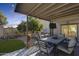 Covered patio with outdoor dining set and sunset view at 14206 W Mandalay Ln, Surprise, AZ 85379