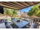 Covered patio with comfortable seating and outdoor dining area at 14206 W Mandalay Ln, Surprise, AZ 85379