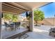 Covered patio with table and chairs, overlooking the backyard at 14206 W Mandalay Ln, Surprise, AZ 85379