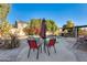 Poolside seating area with red chairs and umbrella at 14206 W Mandalay Ln, Surprise, AZ 85379