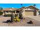 Tan house with cacti landscaping, two-car garage, and desert landscaping at 1498 Leisure World --, Mesa, AZ 85206