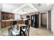 Kitchen with wood cabinets, black appliances, and a glass-top table at 1498 Leisure World --, Mesa, AZ 85206