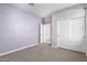 Bedroom with double door closet and purple walls at 1523 S 223Rd Dr, Buckeye, AZ 85326