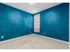 Bedroom with teal walls and window at 1523 S 223Rd Dr, Buckeye, AZ 85326