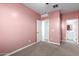 Pink bedroom with access to bathroom at 1523 S 223Rd Dr, Buckeye, AZ 85326