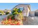 One story house with blue garage door and red flowers at 1523 S 223Rd Dr, Buckeye, AZ 85326