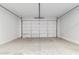 Spacious garage with an automatic garage door and ample storage space at 1523 S 223Rd Dr, Buckeye, AZ 85326