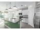 Modern kitchen with green island, granite countertops and stainless steel appliances at 1523 S 223Rd Dr, Buckeye, AZ 85326