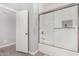 Bright bathroom featuring a white tiled shower and a sliding glass door at 1628 E Magellan Dr, New River, AZ 85087