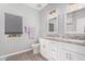 Well-lit bathroom with dual sinks, granite countertops, and stylish fixtures at 1628 E Magellan Dr, New River, AZ 85087