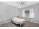 Bright bedroom featuring a ceiling fan, tile floors, and a window with backyard views at 1628 E Magellan Dr, New River, AZ 85087