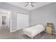 Neutral bedroom with tile flooring, ceiling fan, and closet with view to hallway at 1628 E Magellan Dr, New River, AZ 85087