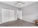 View of a bedroom with tile floor, neutral paint, and a closet with folding doors at 1628 E Magellan Dr, New River, AZ 85087