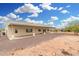 Desert home featuring a large covered patio and native landscaping at 1628 E Magellan Dr, New River, AZ 85087