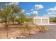 Single-story beige home surrounded by desert landscaping at 1628 E Magellan Dr, New River, AZ 85087