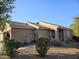 Well-maintained house with a tiled roof and desert landscaping at 16602 W Tasha Dr, Surprise, AZ 85388