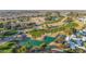 Aerial view showing a golf course, lake, and residential area at 17200 W Bell Rd # 517, Surprise, AZ 85374