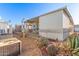 Covered patio, mature plants, and AC unit at 17200 W Bell Rd # 517, Surprise, AZ 85374