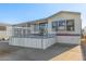 Single-wide manufactured home with carport and elevated deck at 17200 W Bell Rd # 517, Surprise, AZ 85374