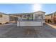 Single-wide manufactured home with carport and elevated deck at 17200 W Bell Rd # 517, Surprise, AZ 85374