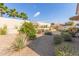 Landscaped backyard with gravel, plants, and a citrus tree at 18114 W Desert Sage Dr, Goodyear, AZ 85338