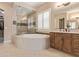 Elegant bathroom featuring a large soaking tub and walk-in shower at 18114 W Desert Sage Dr, Goodyear, AZ 85338