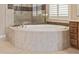 Oval free-standing tub with a walk-in shower at 18114 W Desert Sage Dr, Goodyear, AZ 85338