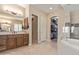 Spa-like bathroom with soaking tub, walk-in shower, and dual vanities at 18114 W Desert Sage Dr, Goodyear, AZ 85338