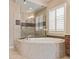 Oval soaking tub and a walk-in shower in a spa-like bathroom at 18114 W Desert Sage Dr, Goodyear, AZ 85338