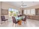 Bright dining area with glass table and wood cabinets at 18114 W Desert Sage Dr, Goodyear, AZ 85338