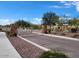 Gated community entrance with stone pillars and landscaping at 18114 W Desert Sage Dr, Goodyear, AZ 85338