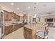 Island kitchen with granite countertops and stainless steel appliances at 18114 W Desert Sage Dr, Goodyear, AZ 85338