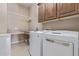 Bright laundry room with washer, dryer, and ample cabinet space at 18114 W Desert Sage Dr, Goodyear, AZ 85338