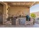 Outdoor kitchen with stainless steel appliances and stone countertops at 18114 W Desert Sage Dr, Goodyear, AZ 85338