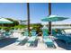 Relaxing pool area with lounge chairs and umbrellas at 18114 W Desert Sage Dr, Goodyear, AZ 85338