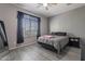 Cozy bedroom with a queen bed, full-length mirror, and window at 1866 N 214Th Ln, Buckeye, AZ 85396