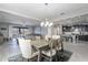 Dining area with a rustic table and chairs, open to the kitchen and living room at 1866 N 214Th Ln, Buckeye, AZ 85396