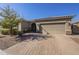 Single-story home with a two-car garage and well-manicured landscaping at 1866 N 214Th Ln, Buckeye, AZ 85396