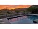 Stunning pool reflecting sunset over mountains at 1866 N 214Th Ln, Buckeye, AZ 85396