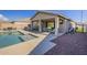 Relaxing pool area with patio furniture and outdoor kitchen at 1866 N 214Th Ln, Buckeye, AZ 85396