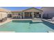 Inviting backyard oasis with a sparkling pool and covered patio at 1866 N 214Th Ln, Buckeye, AZ 85396