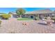 Spacious backyard with gravel, artificial turf, and a stone fountain at 18840 N 83Rd Ln, Peoria, AZ 85382